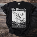 Black t-shirt with "The Monarchs The 3,000 Mile Tour" and butterflies over mountains.