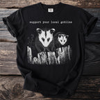 Black t-shirt with two possums and text "support your local goblins".