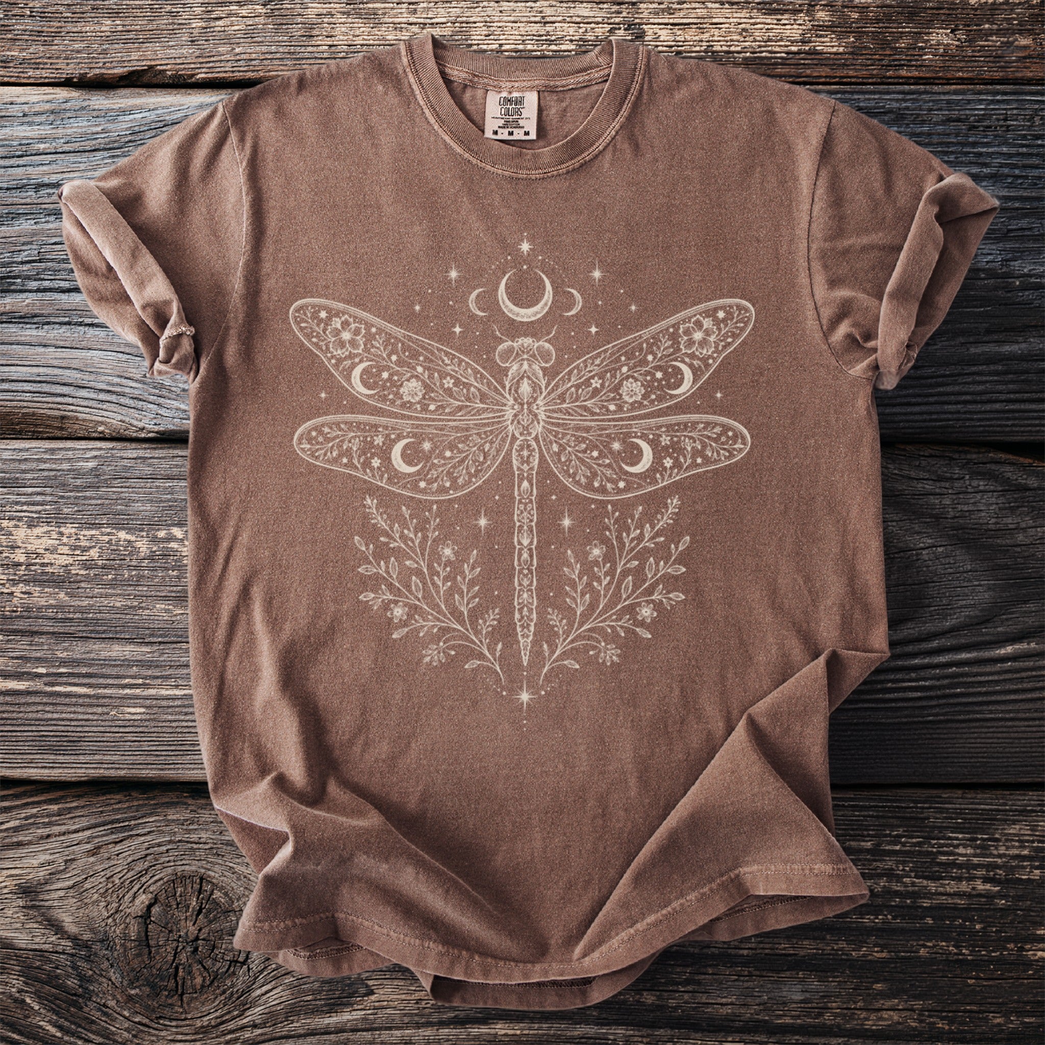 Brown t-shirt with celestial dragonfly and floral design.