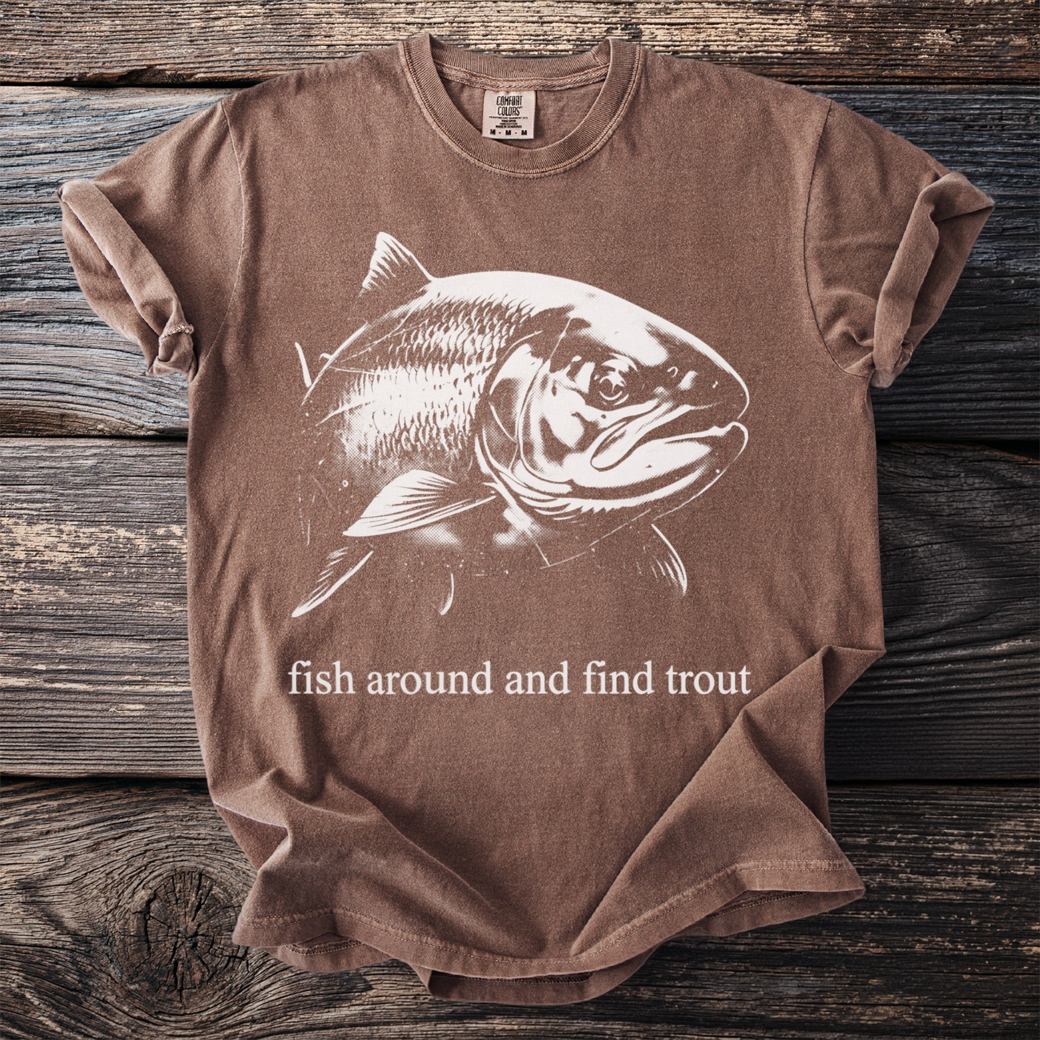 Brown t-shirt with white fish graphic and "fish around and find trout" text.