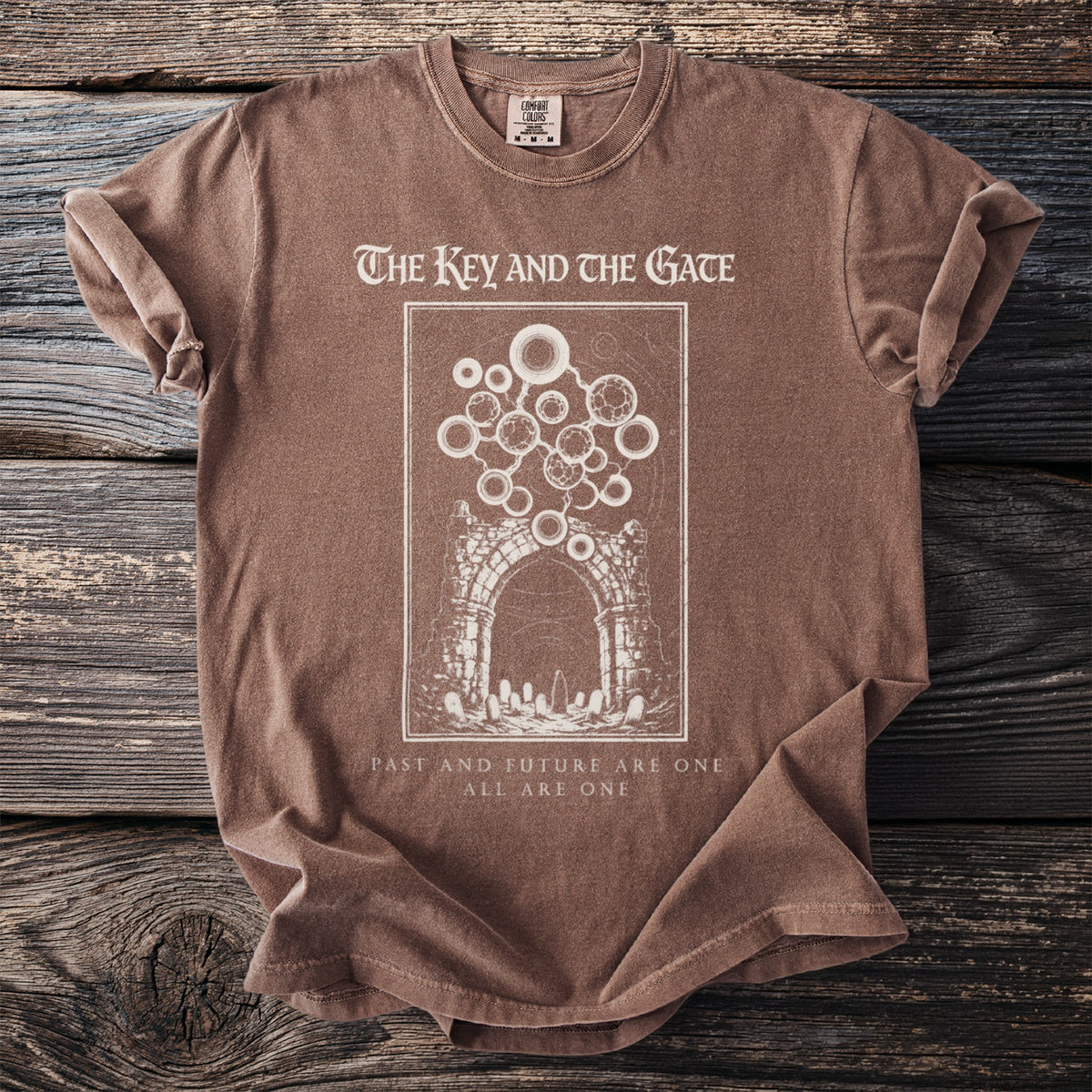 Brown t-shirt with "The Key and the Gate" graphic and text.