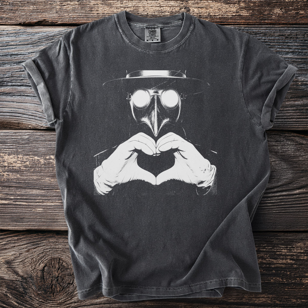 Dark grey t-shirt with a black plague doctor mask and heart hands graphic.