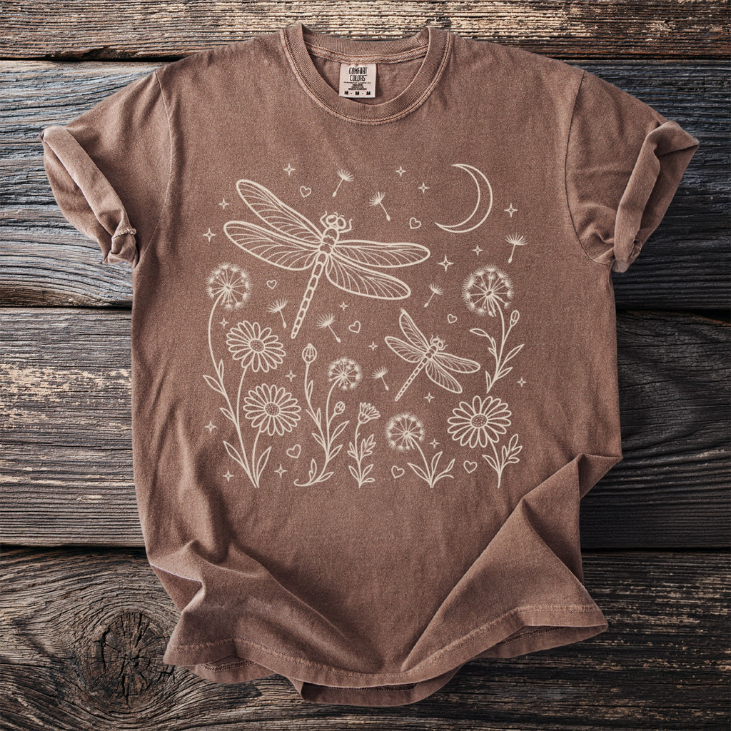 Brown t-shirt with white line art of dragonflies, flowers, and moon.