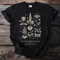Black t-shirt with botanical illustration of wildflowers labeled "The Wildflower Meadow".