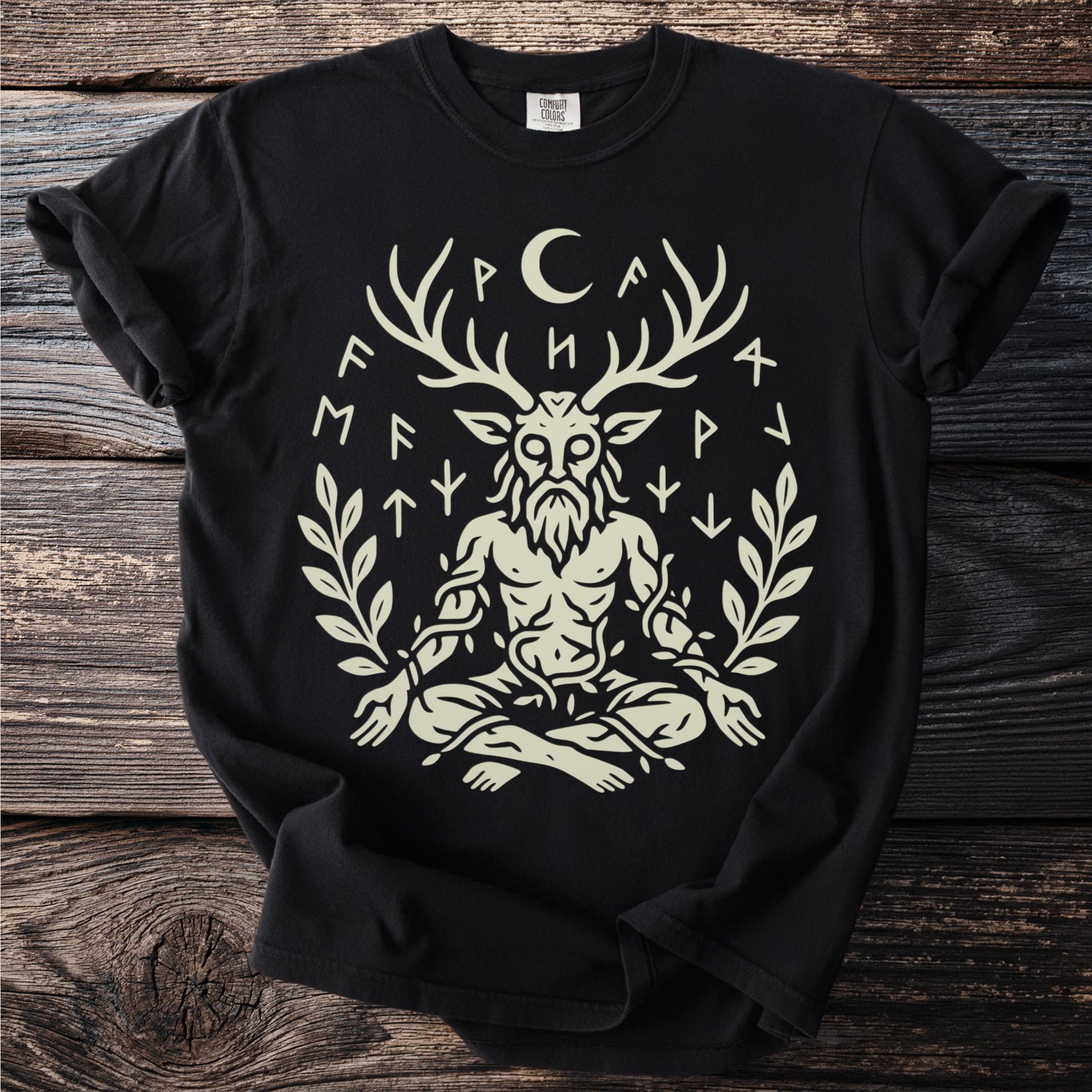 Black t-shirt with a light cream graphic of a seated figure with deer antlers.