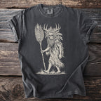 Skull figure with antlers and plant motifs holding a stalk on a dark t-shirt.