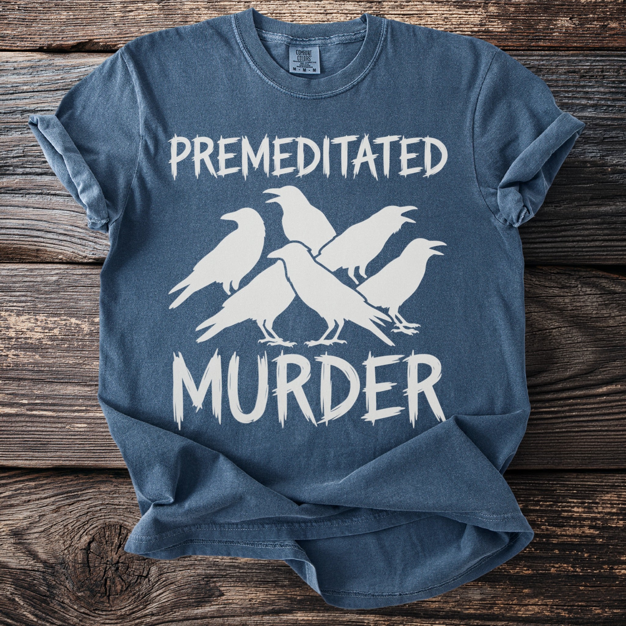 Blue t-shirt with "PREMEDITATED MURDER" and white silhouette of five crows.