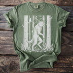 Green t-shirt with white werewolf, owl, moon, trees, and mushrooms design.