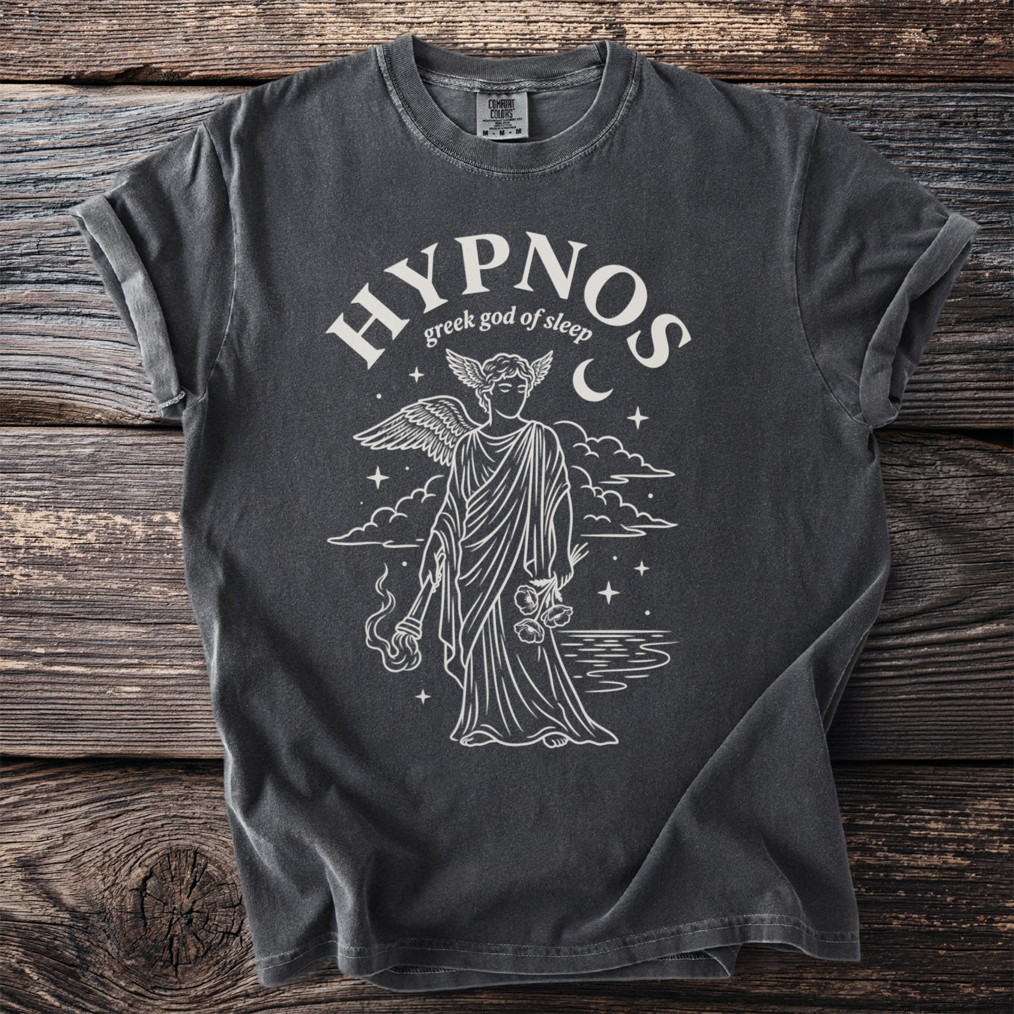 Dark t-shirt with white line art of Hypnos, Greek god of sleep, holding flowers and a torch.
