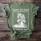 Olive green t-shirt with a graphic of a werewolf and text "born to rest forced to work".