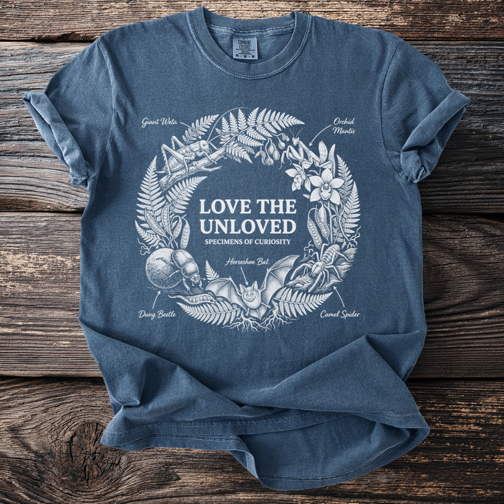 Blue t-shirt with white print "Love the Unloved" and illustrations of insects and animals.