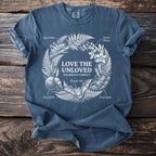 Blue t-shirt with white print "Love the Unloved" and illustrations of insects and animals.