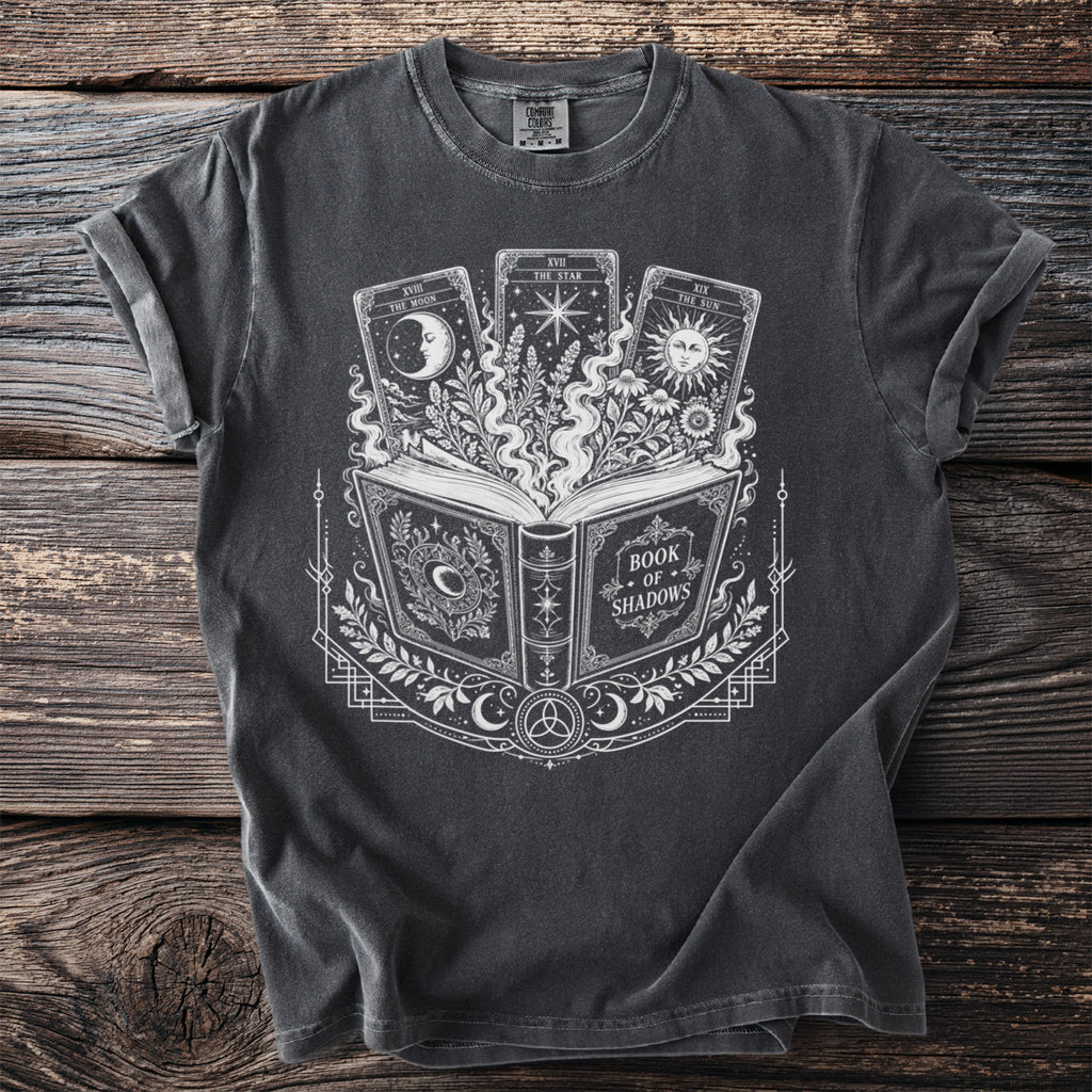 T-shirt with an open book, celestial tarot cards, and occult symbols design.