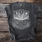 T-shirt with an open book, celestial tarot cards, and occult symbols design.