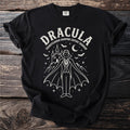 Black t-shirt featuring a white line drawing of Dracula with a castle and bats.