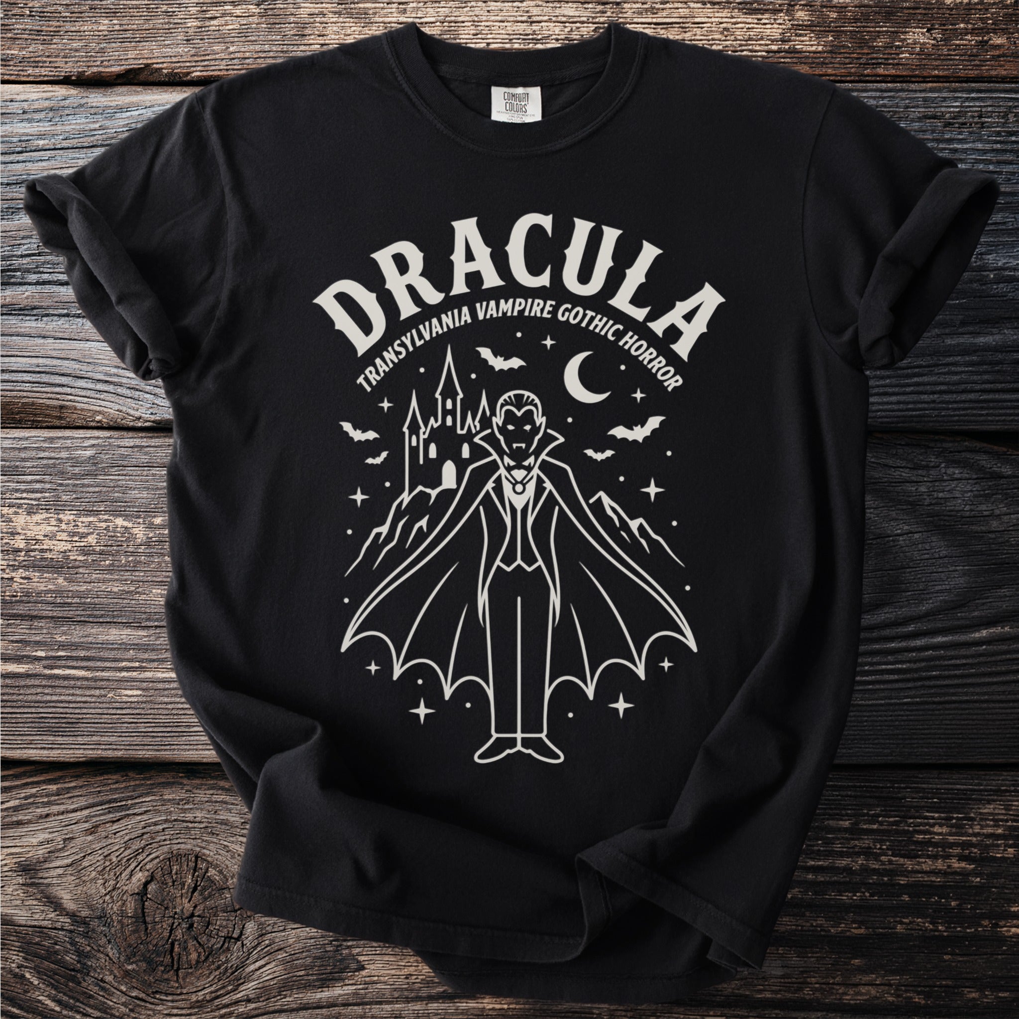 Black t-shirt featuring a white line drawing of Dracula with a castle and bats.