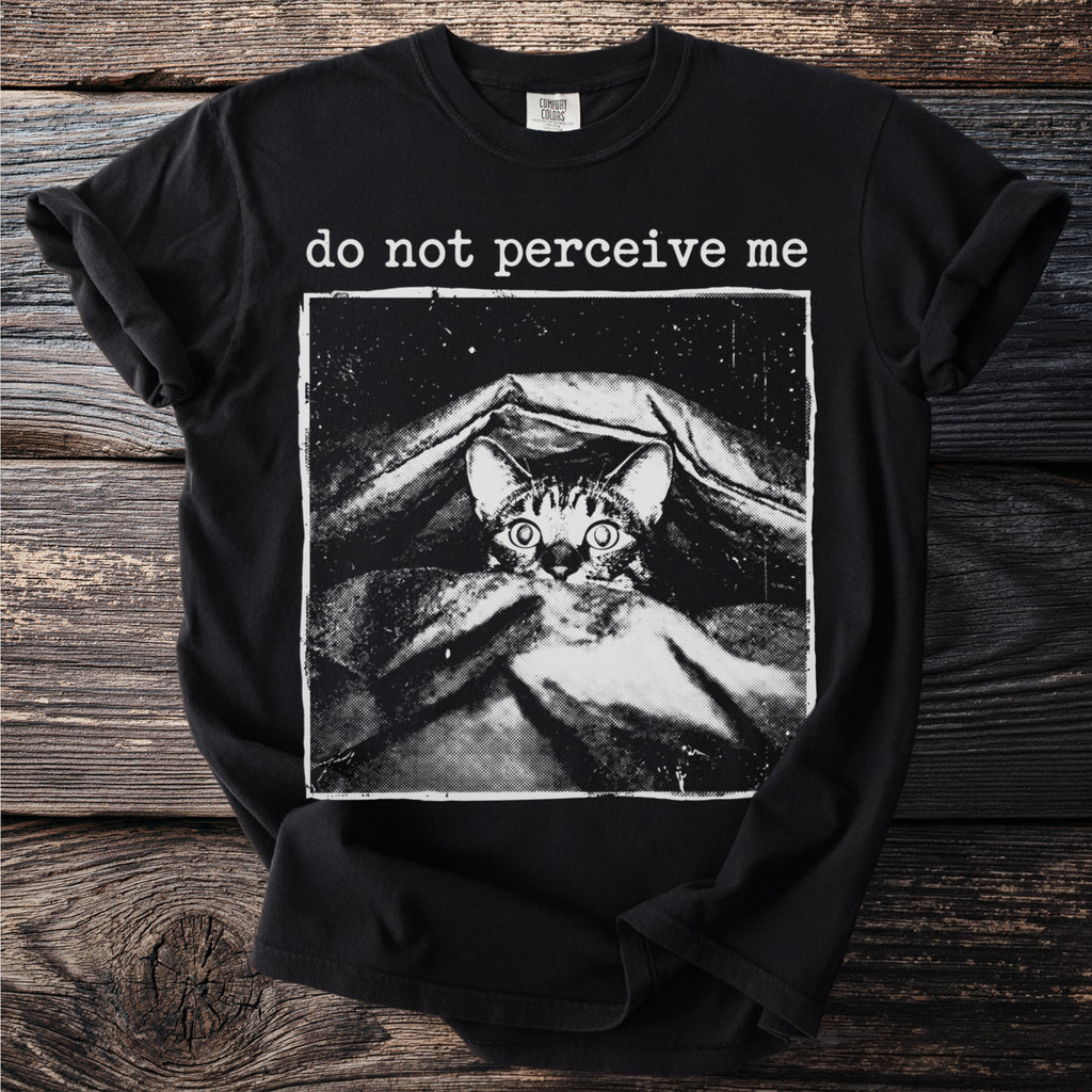 Black t-shirt with a graphic of a cat hiding under blankets and the text "do not perceive me".