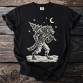 Black t-shirt with a cream folk-cut print: a snarling werewolf in torn trousers walks through the snow with a fir tree over his shoulder.