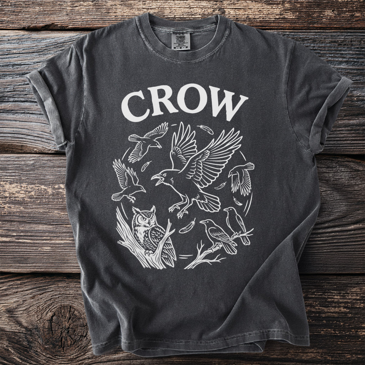 Dark gray t-shirt with white text "CROW" and a circular design of birds and an owl.