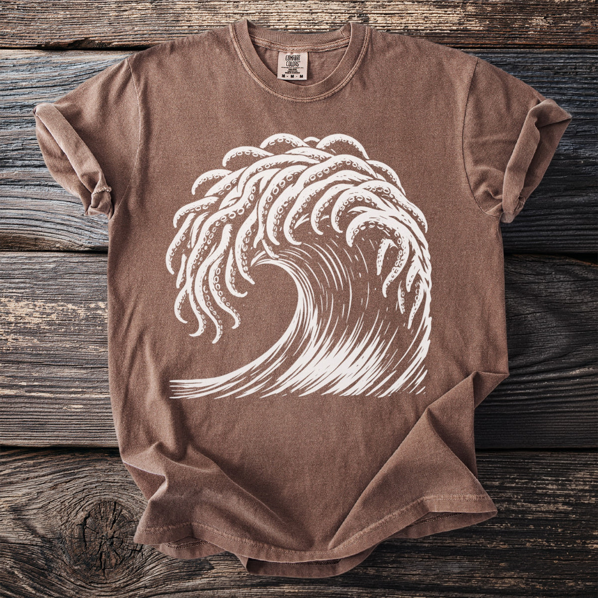Brown t-shirt with a white graphic of an octopus tentacle wave.