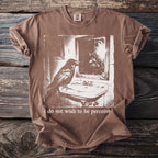 Brown t-shirt with crow in mirror graphic and text "i do not wish to be perceive".