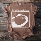 Brown t-shirt with a distressed print of a scared cat in a sink and text "do not perceive me".