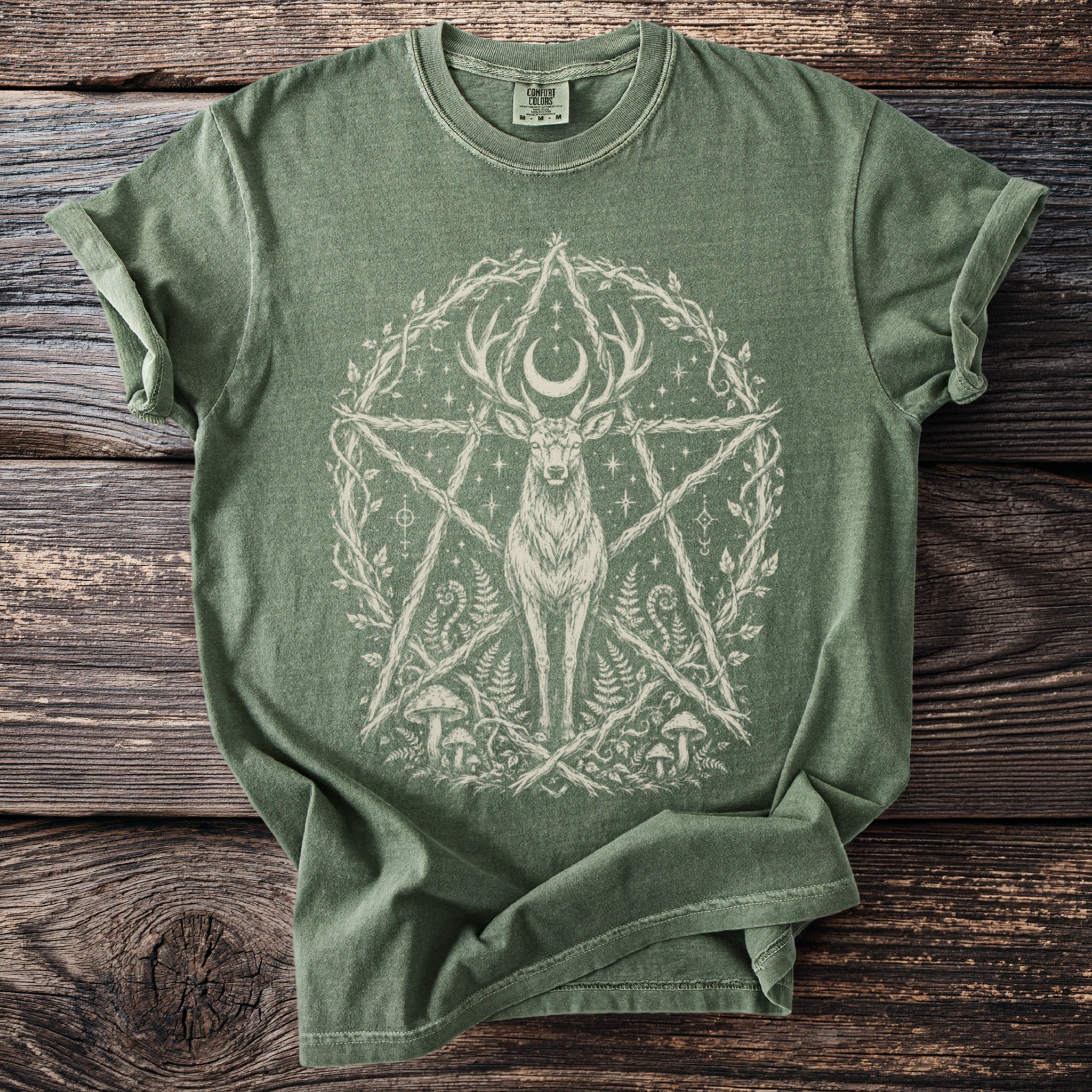 Green t-shirt with a cream-colored mystical stag, moon, and occult symbols design.
