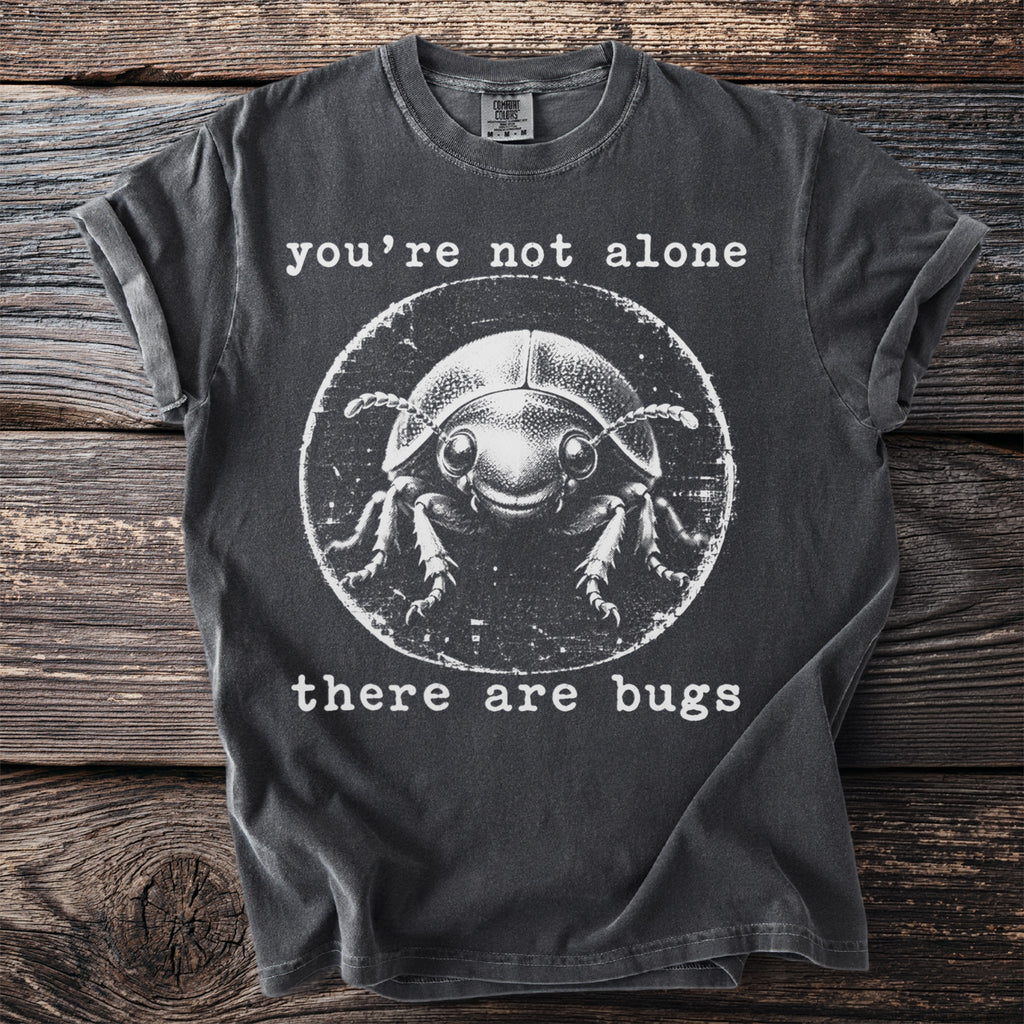 Dark grey t-shirt with a cartoon beetle and text "you're not alone there are bugs".