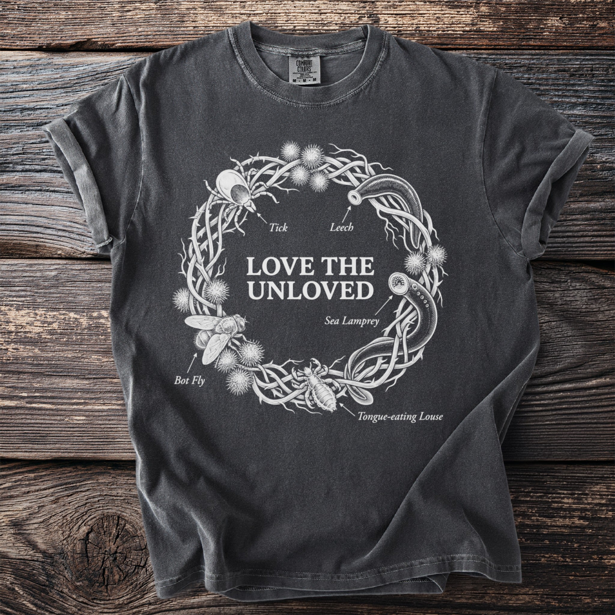 Dark grey t-shirt with a wreath of insects including bot fly, tick, leech, sea lamprey and tongue-eating louse.