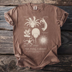 Brown t-shirt with illustration of marine life: coconut crab, mantis shrimp, horseshoe crab, urchin, barnacle, brittle star.