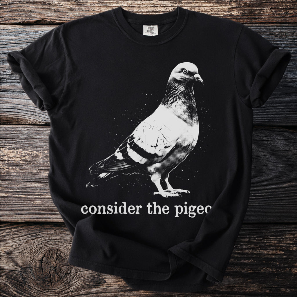 Black t-shirt with a white pigeon graphic and text "consider the pigeon".