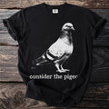 Black t-shirt with a white pigeon graphic and text "consider the pigeon".