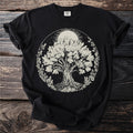 Black t-shirt with a detailed, circular graphic of a tree with roots, surrounded by flowers and a sun.
