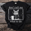 Black t-shirt with cat smoking, a mug, and text "don't tell me what to do".
