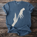 Blue t-shirt with a graphic of two stylized hands with long fingernails.