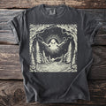 Dark gray t-shirt with a cream graphic of an alien with arms outstretched above a forest and lake.