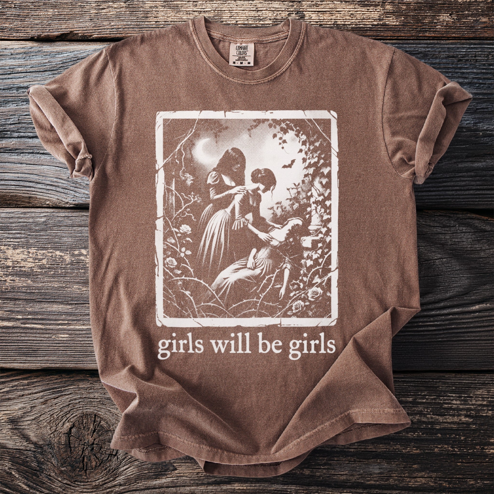 Brown t-shirt with vintage artwork and the text "girls will be girls".
