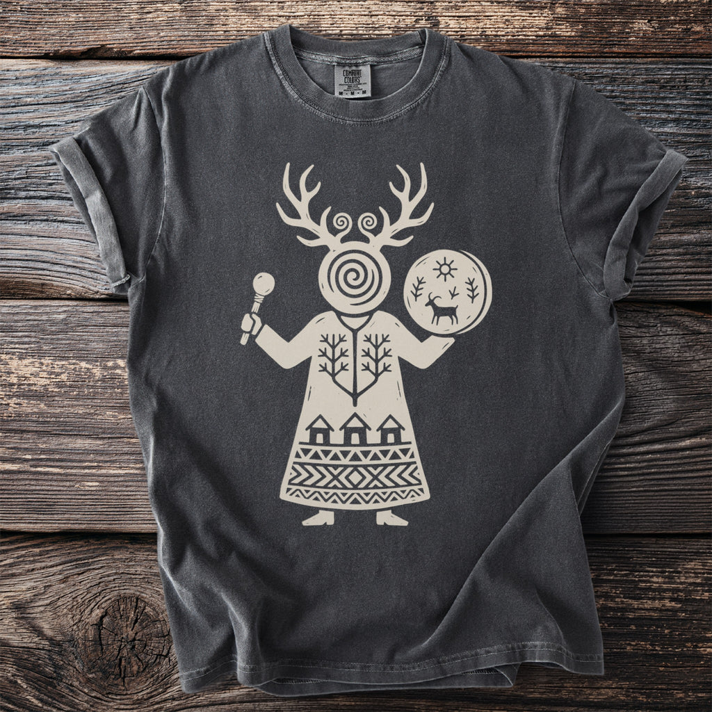 T-shirt with a light beige folk-art design of a figure holding a rattle and drum.