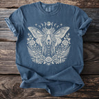 Blue t-shirt with distressed print of a celestial woman with moth wings and floral elements.
