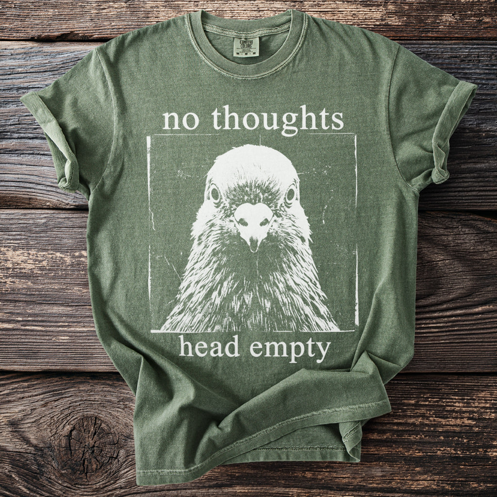 Green t-shirt with a white pigeon graphic and the text "no thoughts head empty".