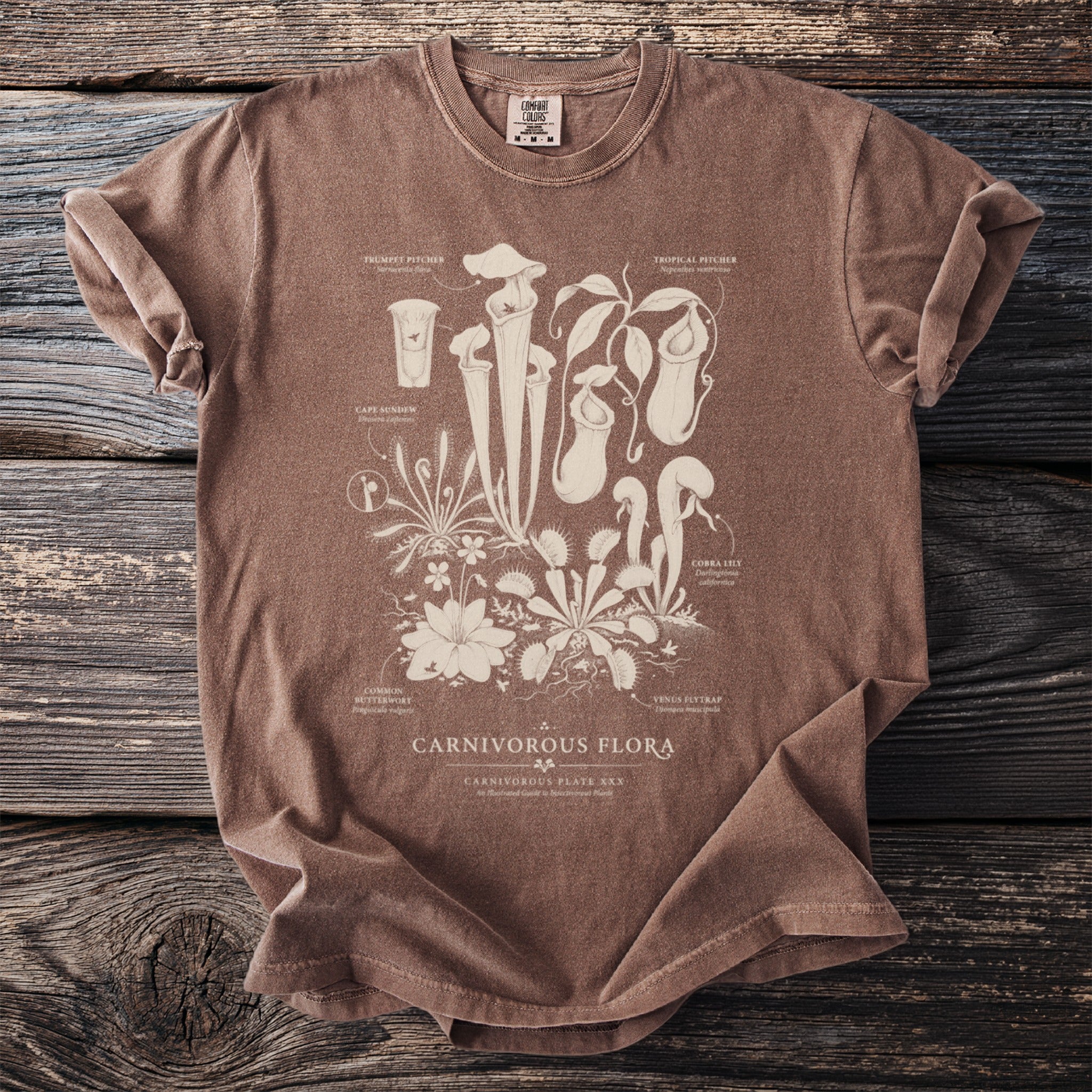 Brown t-shirt with a detailed illustration of carnivorous plants and labels.