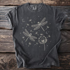 Dark gray t-shirt with cream line art of dragonflies, dandelions, moons, and stars.