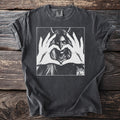 Charcoal t-shirt with black and white graphic of a devil-horned woman forming a heart.