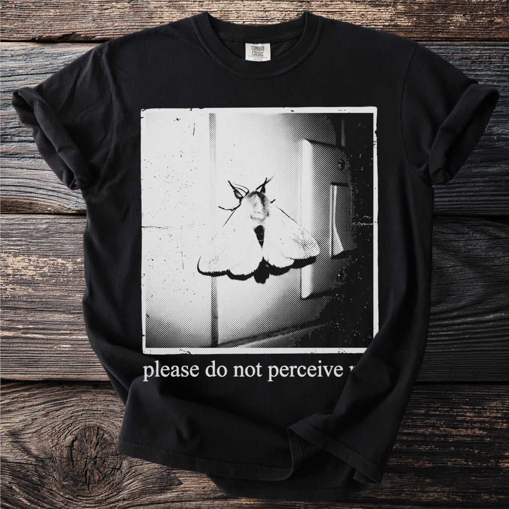 Black t-shirt with a moth on a light switch and the text "please do not perceive".