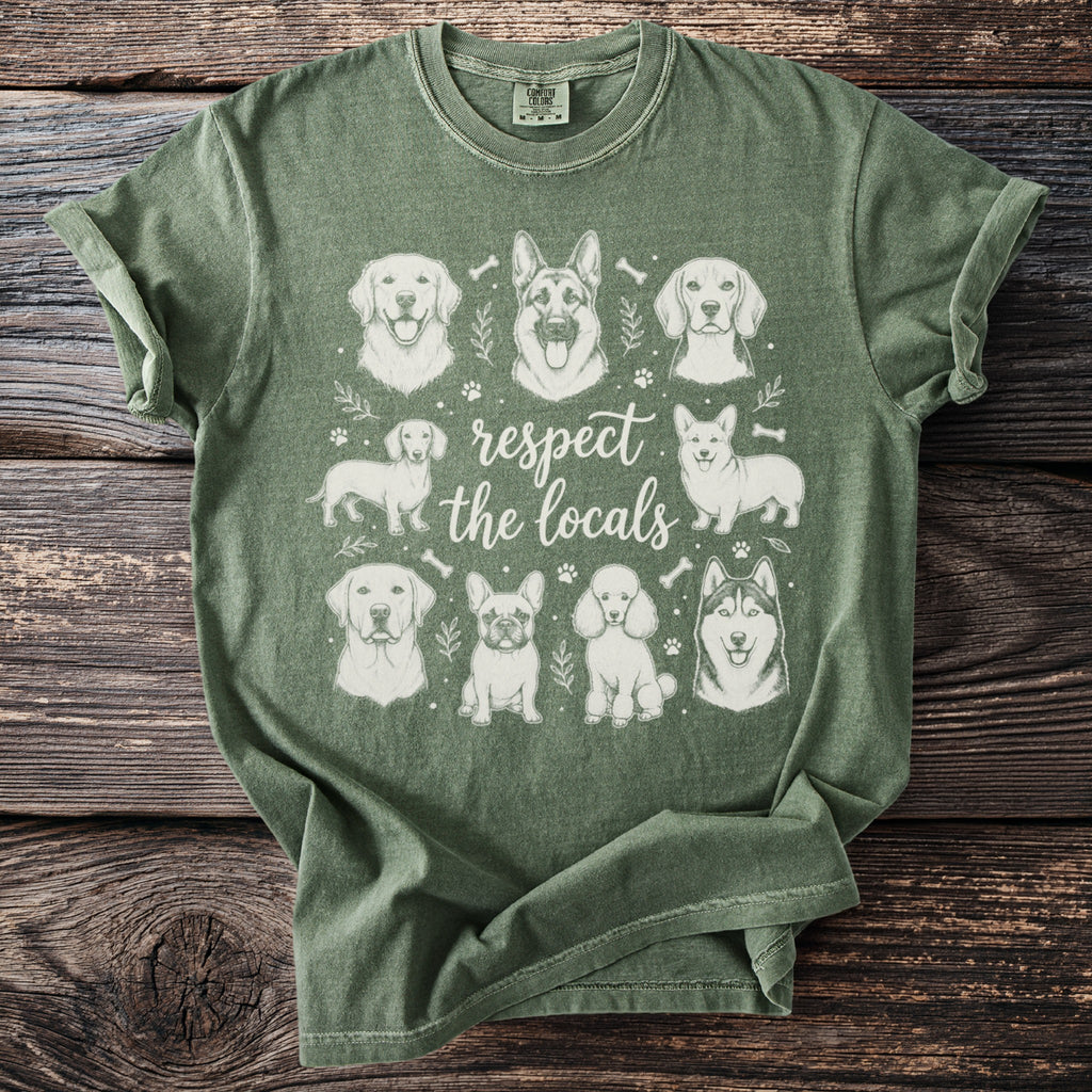 Green t-shirt featuring a collage of nine dog breeds with the text "respect the locals".