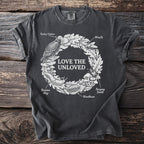 Dark grey t-shirt with "LOVE THE UNLOVED" and a wreath of bugs, slugs, and mushrooms.