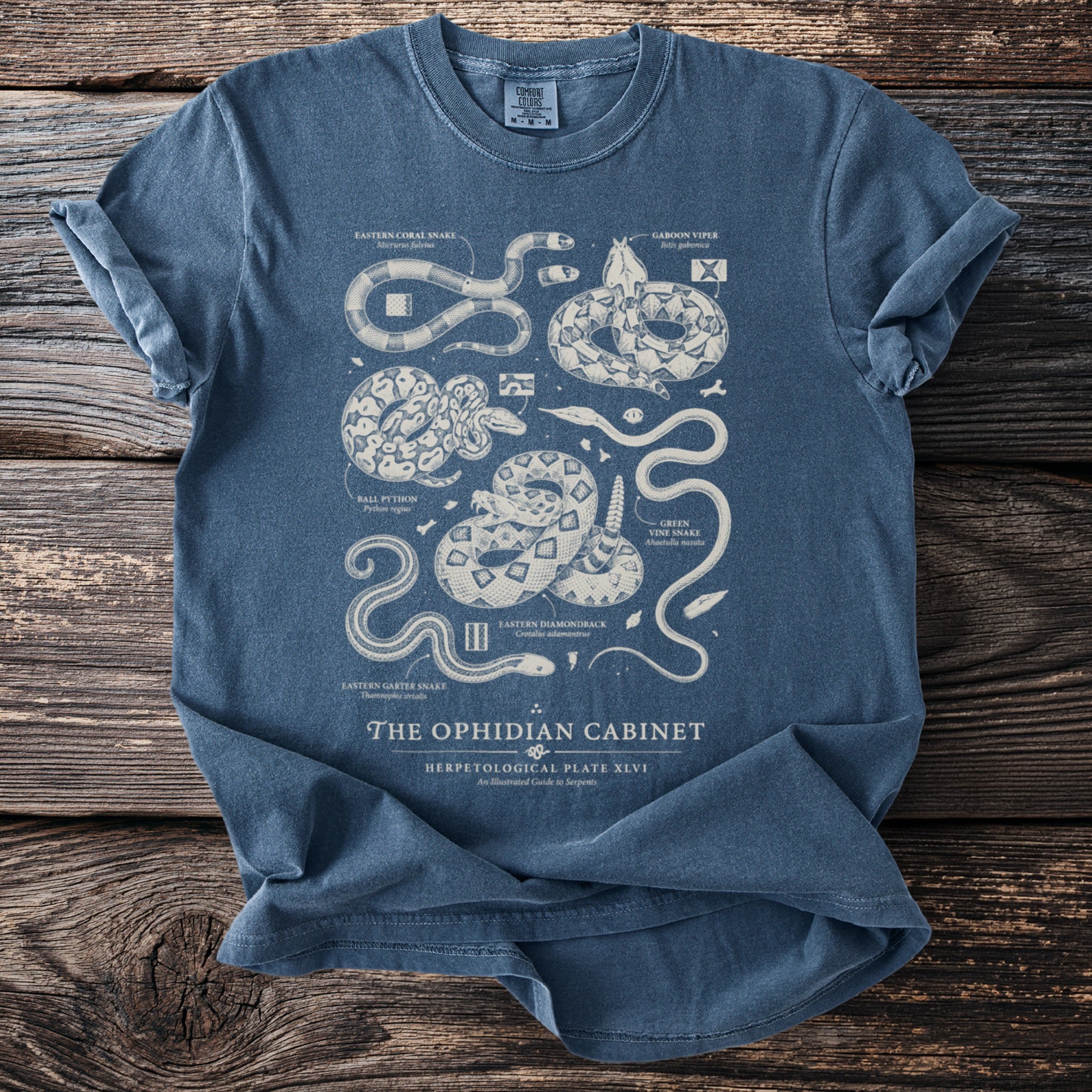 T-shirt design featuring "The Ophidian Cabinet" illustration of various snake species.