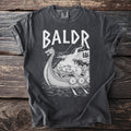 T-shirt with "BALDR" text and Viking funeral scene on a longship.
