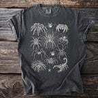 Dark t-shirt with a white line drawing of various spiders and a scorpion on a web.