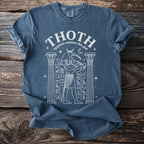 T-shirt with white line art of Thoth, Egyptian ibis god, between columns.